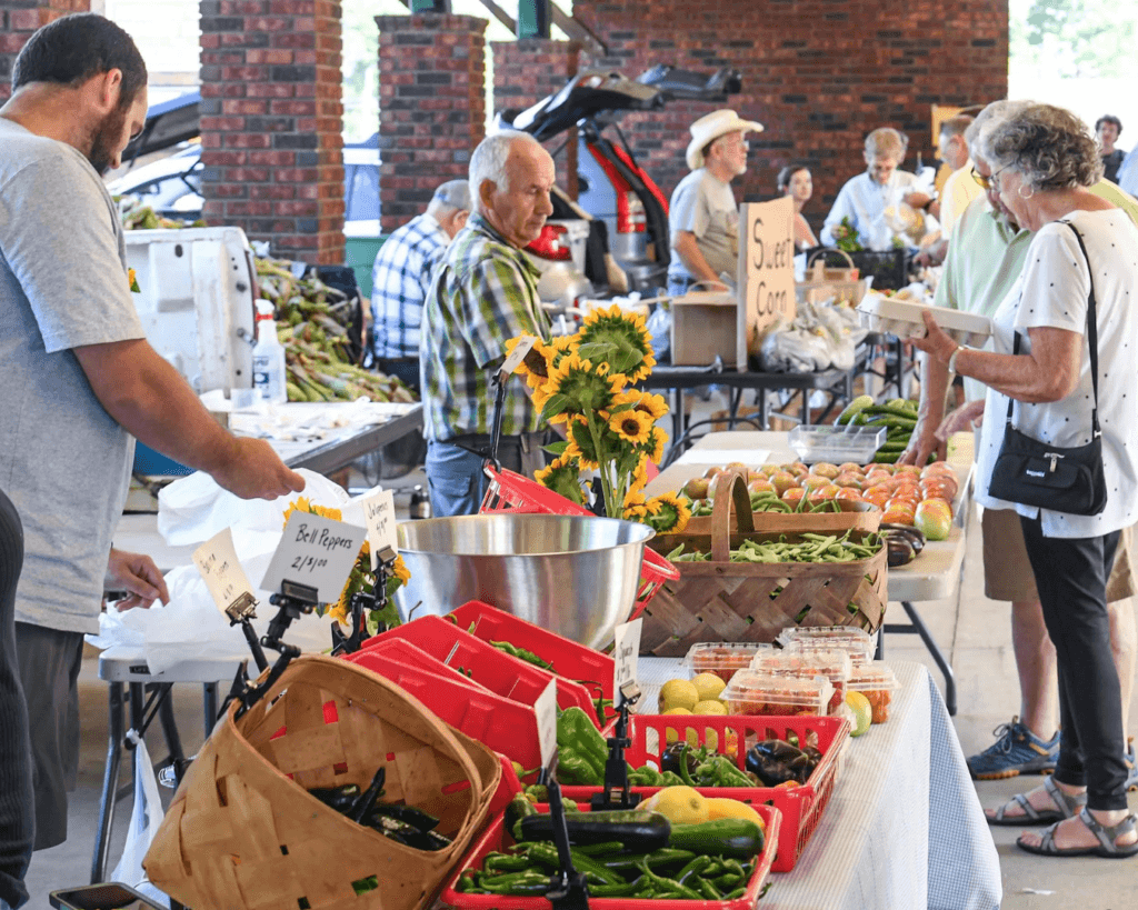 People buying produce during the season opening day of Anderson County Farmer's Market in Anderson June 18 2022. Photo Credits: Ken Ruinard / Independent Mail.